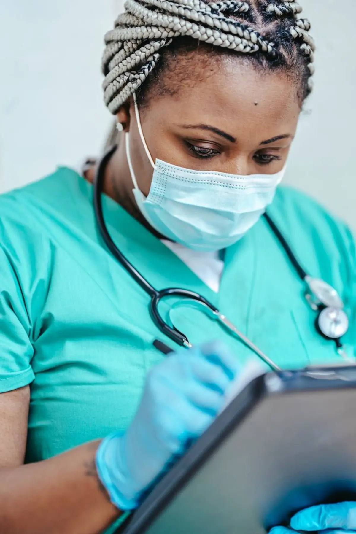 A Network One Health midwife caring for a patient